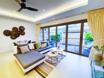 a living room with a couch and a table at Beautiful 1br Plunge Pool Villa Walk To Bangtao Beach in Ban Thalat Choeng Thale
