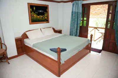 a bedroom with a bed in a room with a window at Lam Sai village hotel Koh Yao Noi in Ko Yao Noi