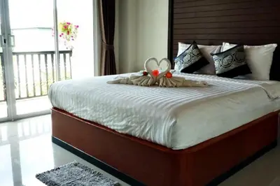a bedroom with a bed with a stuffed animal on it at Vivi Boutique Room Hotel SHA Plus in Rawai Beach