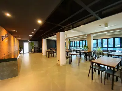 a dining room with tables and chairs and windows at Aonang Dugong-SHA Extra Plus in Ao Nang Beach
