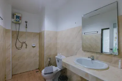 a bathroom with a sink and a toilet and a mirror at Royal Beach Residence, Patong Beach in Patong Beach