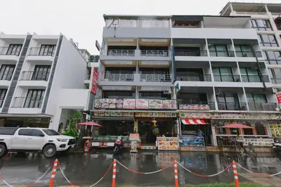 a building on a city street in the rain at Royal Beach Residence, Patong Beach in Patong Beach