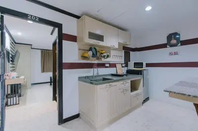 a kitchen with a sink and a counter top at Royal Beach Residence, Patong Beach in Patong Beach