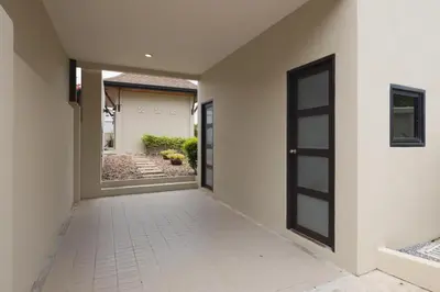 an empty hallway with a door and a tile floor at Foxtail Palm Villa in Rawai Beach