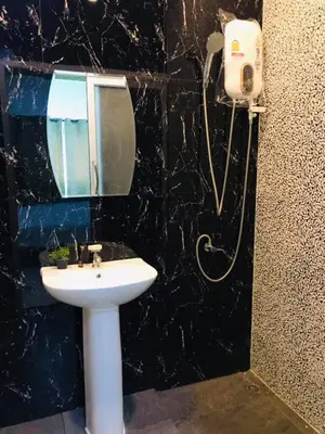 a bathroom with a sink and a mirror at นิวเวฟภูเก็ต in Ban Na Kok