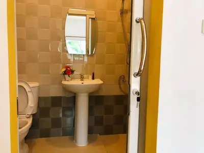 a bathroom with a sink and a toilet at นิวเวฟภูเก็ต in Ban Na Kok