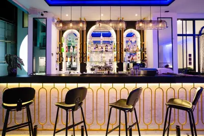 a bar with four chairs in front of it at Ratri Hotel Phuket Old Town in Phuket Town