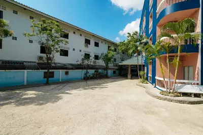 arial view of a building with a pool and trees at Mayfa Hotel - SHA extra plus in Phuket Town