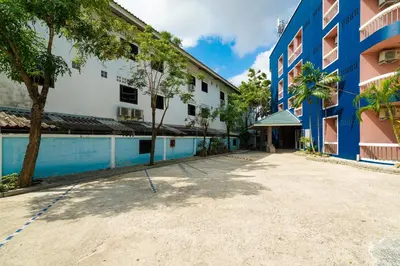 an empty courtyard of a building with a swimming pool at Mayfa Hotel - SHA extra plus in Phuket Town