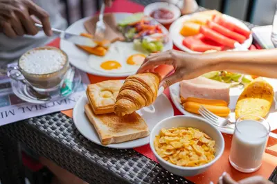 a table full of breakfast food with eggs and toast at Citrus Patong Hotel by Compass Hospitality in Patong Beach