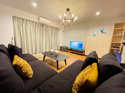 a living room with a couch and a table at The Nakara Town in Ban Rangeng