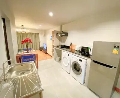 a kitchen with a washing machine and a washer at The Nakara Town in Ban Rangeng