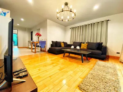 a living room with a couch and a table at The Nakara Town in Ban Rangeng