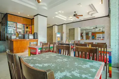 a dining room with a table and chairs at Art Mansion Patong Hotel in Patong Beach