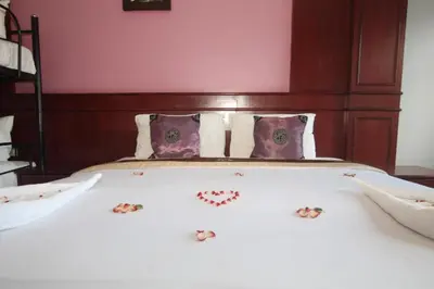 a bedroom with a bed with hearts on it at Art Mansion Patong Hotel in Patong Beach