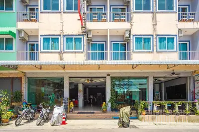 a building with motorcycles parked in front of it at Art Mansion Patong Hotel in Patong Beach