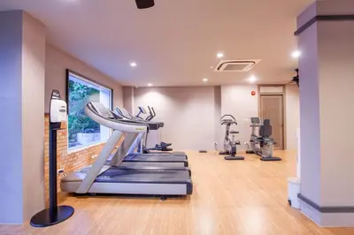 a gym with treadmills and elliptical machines at Zenmaya Oceanfront Phuket, Trademark Collection by Wyndham in Patong Beach
