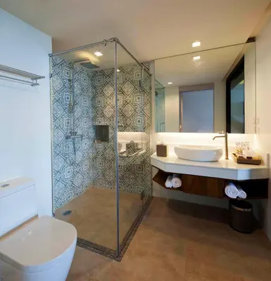 a bathroom with a shower and a toilet and a sink at Zenmaya Oceanfront Phuket, Trademark Collection by Wyndham in Patong Beach