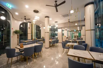 a restaurant with tables and chairs in a room at Poolrada Boutique Hotel - SHA Plus in Thalang
