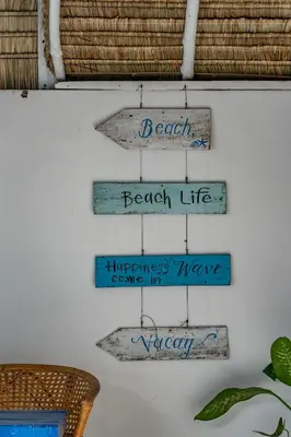 a shelf with four signs on a wall at Soul Villas - Beachfront Private Pool Villas, Phuket Nature Retreat in Panwa Beach
