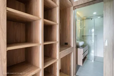 a bathroom with wooden shelves and a sink at 2-Bedroom Apartment at Calypso Garden Residences in Rawai Beach