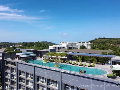 an aerial view of a building with a swimming pool at 2-Bedroom Apartment at Calypso Garden Residences in Rawai Beach