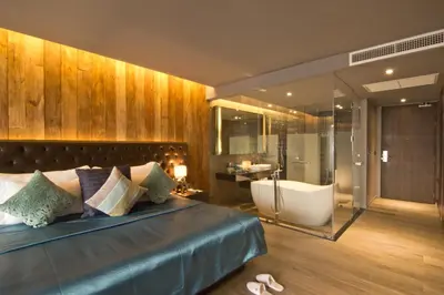 a bedroom with a bed and a tub and a sink at Le Coral Resort in Natai Beach