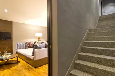 a staircase leading to a living room with a couch at Le Coral Resort in Natai Beach