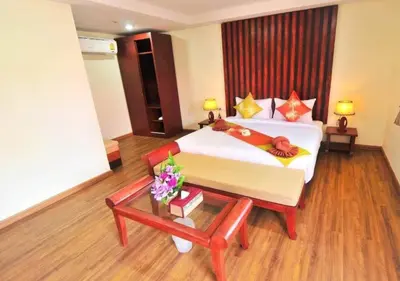 a hotel room with a bed and a table at Phi Phi Ba Kao Bay Resort in Phi Phi Don