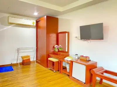 a room with a desk and a tv on a wall at Phi Phi Ba Kao Bay Resort in Phi Phi Don