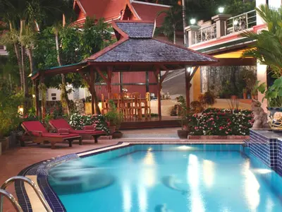 a swimming pool in front of a gazebo at Kata Sea View Villas in Kata Beach