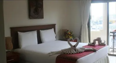 a bedroom with a bed with a heart decoration on it at Palmview Resort in Patong Beach
