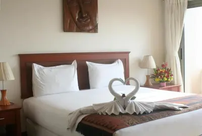 a bedroom with a bed with a heart decoration on it at Palmview Resort in Patong Beach