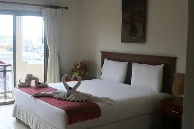 a bedroom with a bed with two hearts on it at Palmview Resort in Patong Beach