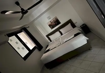 a bedroom with a bed and a ceiling fan at Beverly Hills Villa Patong in Patong Beach