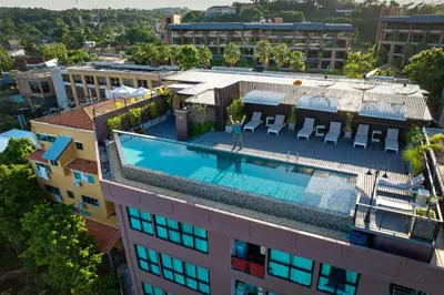 an overhead view of a building with a swimming pool at The Proud Rawai Resort in Rawai Beach