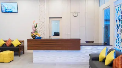 a living room with yellow and blue pillows at Tuana Hotels Brook Pool Access in Chalong