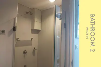 a shower with a glass door in a bathroom at Pool Access 2 BDR Stylish Condo in Kamala Beach
