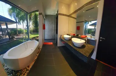 a bathroom with two sinks and a large tub at Eden Villa Phuket in Bang Tao Beach