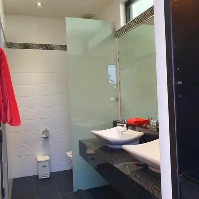 a bathroom with two sinks and a mirror at Eden Villa Phuket in Bang Tao Beach