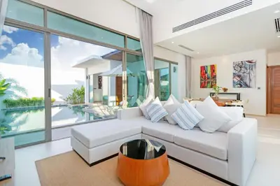 a living room with a white couch and a table at Shambhala Grand Villa - Private Pool Villas by Escape Villas - Top Choice - Guest Favorite - Best Location in Bang Tao Beach