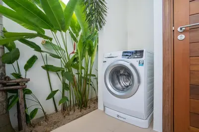 a washing machine in a room with plants at Shambhala Grand Villa - Private Pool Villas by Escape Villas - Top Choice - Guest Favorite - Best Location in Bang Tao Beach
