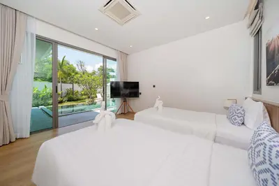 two white beds in a room with a large window at Shambhala Grand Villa - Private Pool Villas by Escape Villas - Top Choice - Guest Favorite - Best Location in Bang Tao Beach