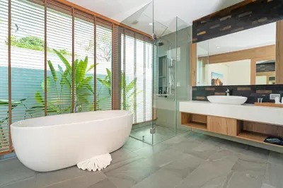 a bathroom with a large tub and a sink and a mirror at Shambhala Grand Villa - Private Pool Villas by Escape Villas - Top Choice - Guest Favorite - Best Location in Bang Tao Beach