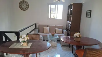 a living room with two tables and a couch at Suwita House in Nai Yang Beach
