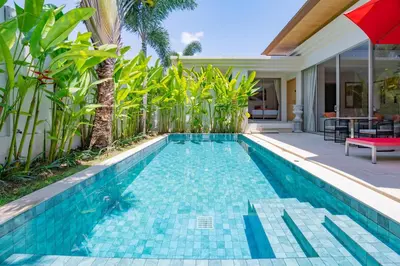 a swimming pool in a villa with an umbrella at 3BR Villa with Private Pool in Trichada Sky at Bangtao Beach in Bang Tao Beach