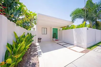 a white house with a white fence and plants at 3BR Villa with Private Pool in Trichada Sky at Bangtao Beach in Bang Tao Beach