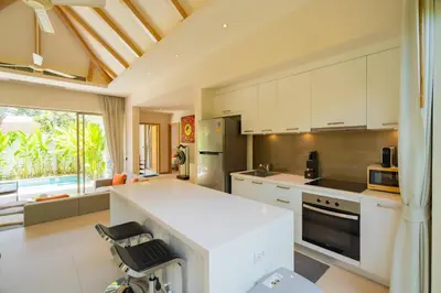a kitchen with white cabinets and a white counter top at 3BR Villa with Private Pool in Trichada Sky at Bangtao Beach in Bang Tao Beach