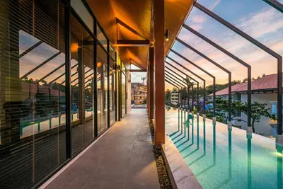 a view of a building with a swimming pool at Apartment at Palmyrah Surin by Lofty in Surin Beach