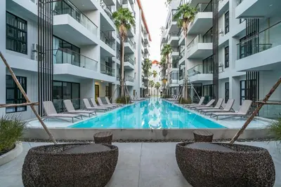 a swimming pool in the middle of a building at Apartment at Palmyrah Surin by Lofty in Surin Beach